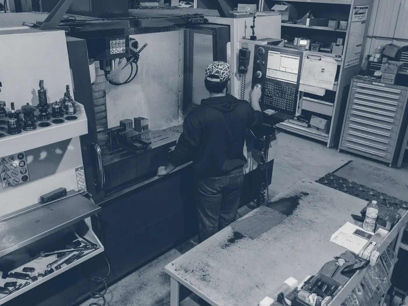 A machinist at the control of a Haas VF-4 at Cherry Creek Machine